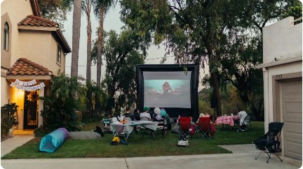 Family enjoying backyard movie